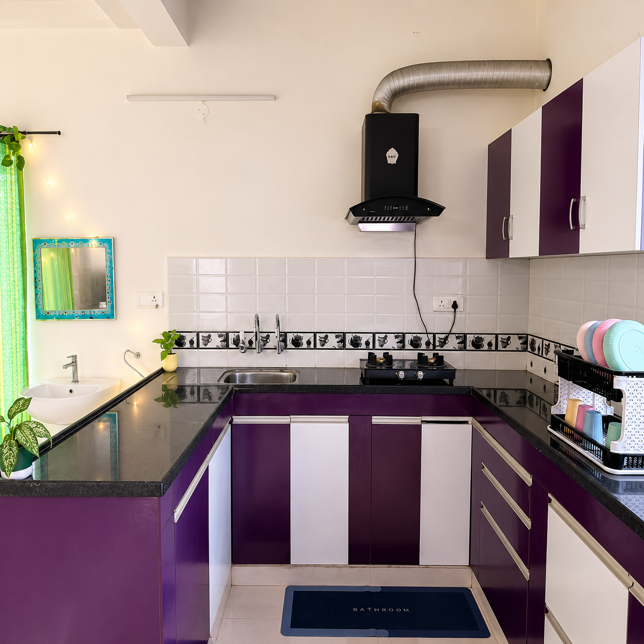Modern kitchen, stylish kitchen interior, purple kitchen cabinets, white kitchen cabinets, black granite countertop, modular kitchen, U-shaped kitchen, compact kitchen, clean kitchen design, contemporary kitchen, bright kitchen, functional kitchen, organized kitchen, apartment kitchen, rental kitchen, student-friendly kitchen, student accommodation kitchen, student cooking space, study-friendly home kitchen, budget-friendly kitchen, easy cooking space, practical kitchen setup, work-from-home kitchen, business professional kitchen, professional-friendly kitchen, quick meal preparation, busy lifestyle kitchen, convenient kitchen layout, efficient kitchen storage, spacious countertop, modern sink area, gas stove kitchen, kitchen chimney, kitchen exhaust hood, kitchen dish rack, kitchen storage cabinets, glossy kitchen surfaces, tiled kitchen backsplash, indoor plants kitchen, natural light kitchen, vibrant kitchen decor, minimalist kitchen style, urban home kitchen, shared accommodation kitchen, bachelor-friendly kitchen, family kitchen, meal prep kitchen, home cooking area, modern home interior, real estate kitchen keywords